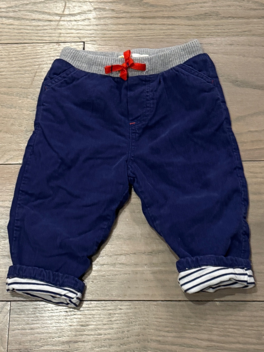 Baby Boden Navy Blue Corduroy with Striped Cuffs and Red Bow